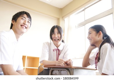 Three Japanese Students Talking And Laughing