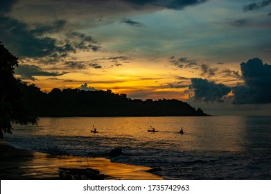 Three Kayakers At Sunset At Sea In Drakes Bay