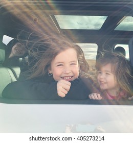 Three Kids In A Car Together Looking Out The Window With Instagram Effect