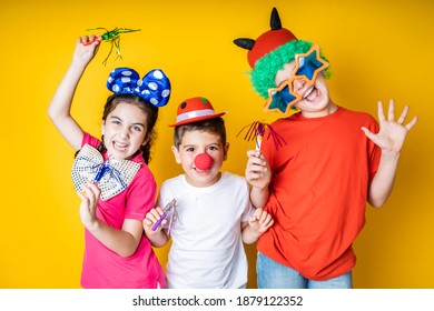 Three Kids Celebrating Carnival Or New Years Eve At Home