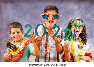 Three Kids Celebrating New Years Eve. 2022!