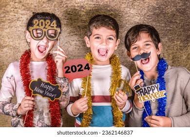 Three kids celebrating New Years Eve. 2024! - Shutterstock ID 2362146837