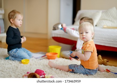 Three Kids Playing Together At Home