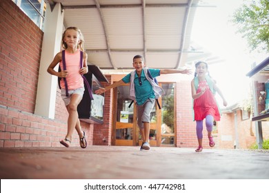 Three Kids Running In The Playground On A Sunny Day