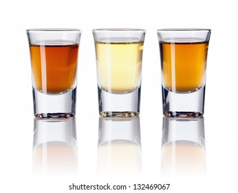 Three kinds of alcoholic drinks in shot glasses