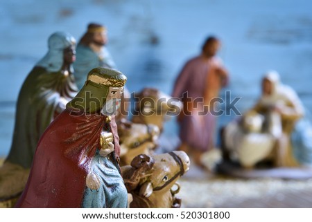 the three kings on their camels and the holy family in a rustic nativity scene