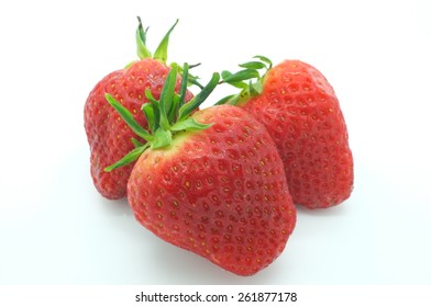Three korean strawberries isolated on white background