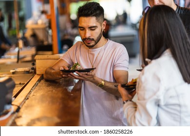 Three Latin Friends Eating Tacos At Night