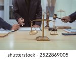 Three lawyers in a meeting at the table in an office, discussing business, civil and commercial law, labor law, marketing and advertising law,offering legal consulting and case management services.