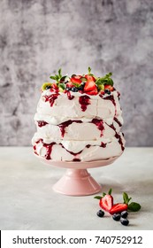 Three Layer Pavlova Cake with Whipped Cream, Raspberry Jam and Assorted Fruit and Berries, copy space for your text