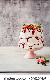 Three Layer Pavlova Cake with Whipped Cream, Raspberry Jam and Assorted Fruit and Berries, copy space for your text