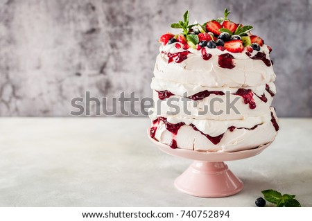 Three Layer Pavlova Cake with Whipped Cream, Raspberry Jam and Assorted Fruit and Berries, copy space for your text