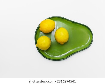 Three lemons  on green ceramic plate  for lemonade making. White table background  with copy space. Top view. - Shutterstock ID 2316294541