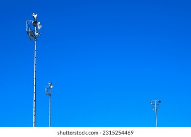 Three light posts on a school baseball field