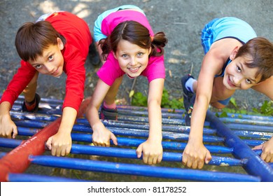 Three little children climbing ladder and looking at camera - Powered by Shutterstock