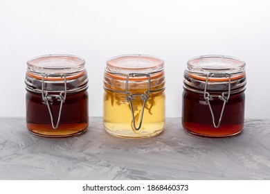 Three Little Jars With Homemade Honey, Jam And Quince Syrup