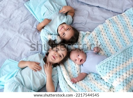 Similar – Little girl embracing doll lying over the bed