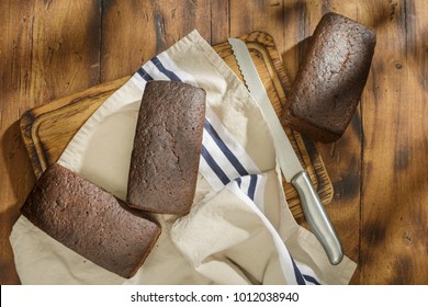 Three Loaf Of Rye Bread On A Dark Surface, Top View