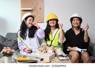 Three Lovely Asian Kids In Safety Helmet Pretend To Be Engineer Playing Together At Home.