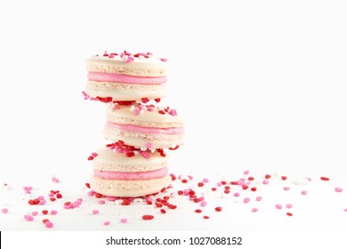 Three Macarons with Heart Shaped Sprinkles and Cherry Filling Stacked.