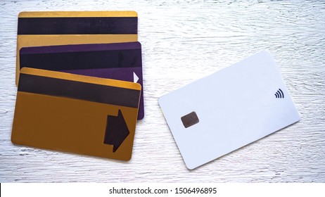 Three Magnetic Stripe ATM Card And New ATM Is A Chip Card System Put On White Wood Flooring. Concept  Changing The System From A Magnetic Stripe To A Chip Card.