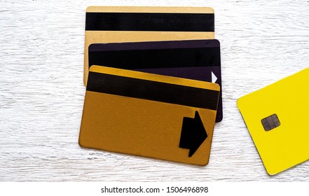 Three Magnetic Stripe ATM Card And New ATM Is A Chip Card System Put On White Wood Flooring. Concept  Changing The System From A Magnetic Stripe To A Chip Card.