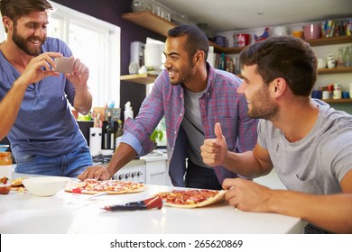 Three Male Friends Making Pizza In Kitchen Together - Powered by Shutterstock