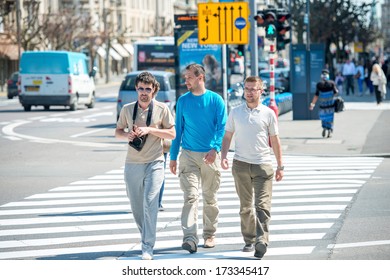 Three Male Friends Walking Down The Street