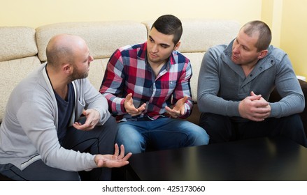 Three Males Having A Serious Conversation At Home