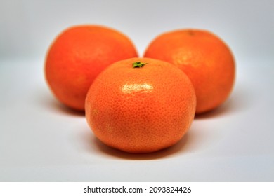 Three mandarins on white background, closeup. High quality photo
