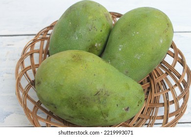 Three Mangoes In A Rattan Plate On The Table