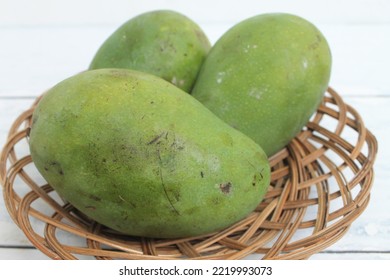 Three Mangoes In A Rattan Plate On The Table