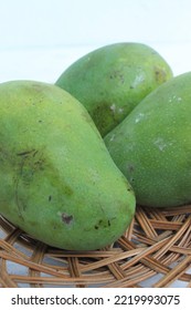 Three Mangoes In A Rattan Plate On The Table