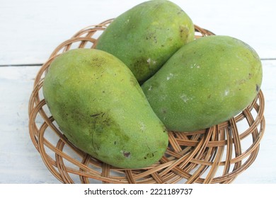 Three Mangoes In A Rattan Plate On The Table