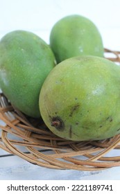 Three Mangoes In A Rattan Plate On The Table