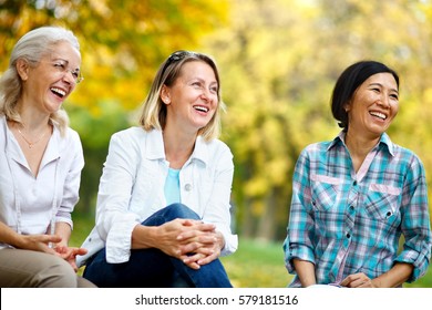 Three Mature Ladies Outdoors Enjoying And Laughing 