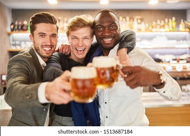 Three Men As Best Friends Celebrate Hilariously With Beer On A Pub Crawl