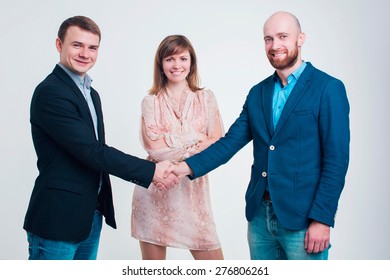 Three Men In Business Suits Talking On A White Background 