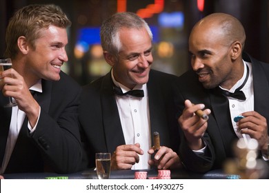 Three men gambling at roulette table in casino - Powered by Shutterstock