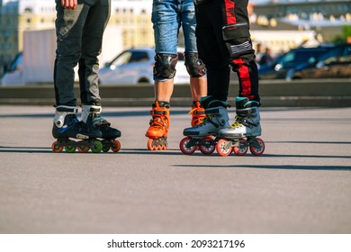 Three Men Rollerblading In The City, No Faces. Outdoor Activity.