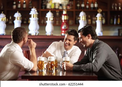 Three Men In Shirts In The Bar