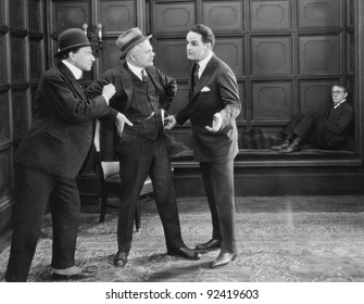 Three Men Standing Together Arguing