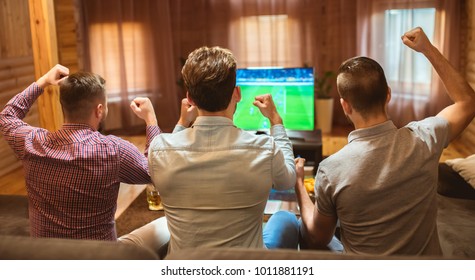 The Three Men Watch A Football And Gesture