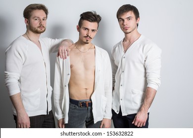 Three Men In A White Cardigan Over His Naked Body In The Studio