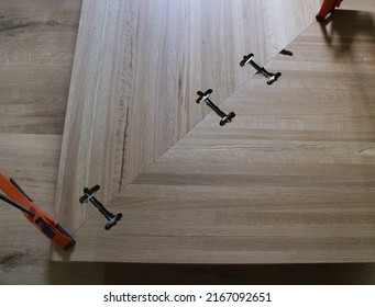 Three Metal Brackets Holding Together A White Oak Butcher Block Countertop Corner