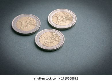 Three Metal Coins With A Face Value Of Two Euros Are On The Table.