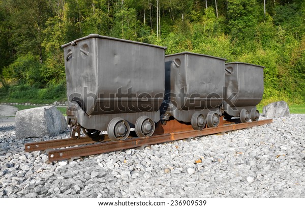 Three mine carts\
on rails - mining monument in a roundabout on the outskirts of Sulz\
am Neckar, Germany. 