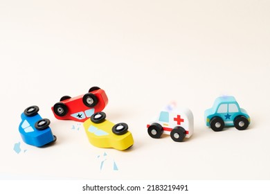 Three Mini Toy Car Crash. Ambulance And Police Car On The Way With Help. Car Incident, To Fast Driving.