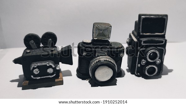 three miniature vintage\
black camera