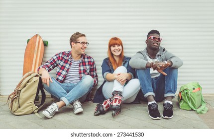 Three Mixed Race Friends Sitting And Having Fun. Concept About People And Youth